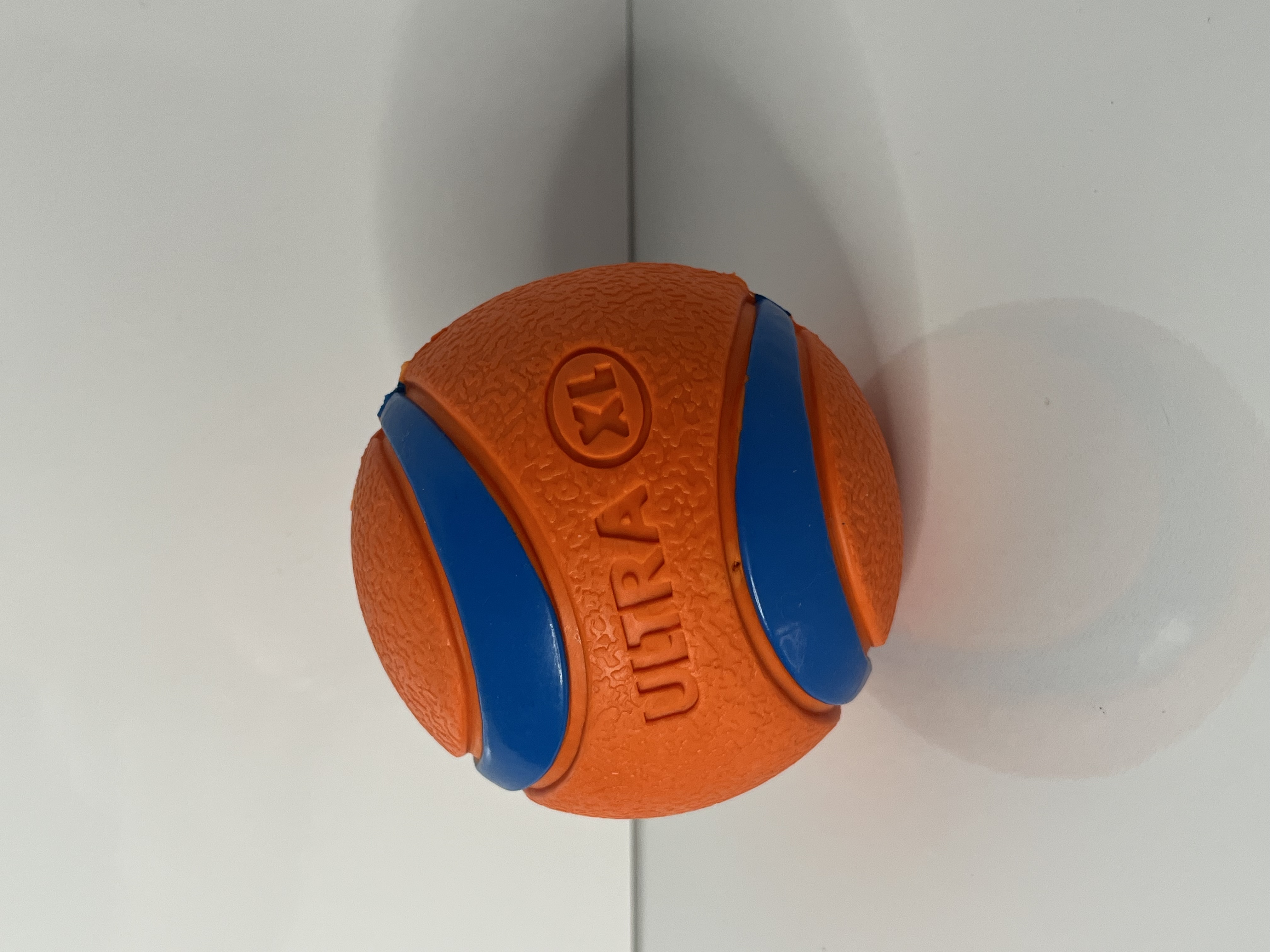 The same ball is tilted at an angle, highlighting the embossed 'ULTRA XL' text and its curved grooves.